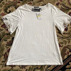 White top with lace cutout sleeves